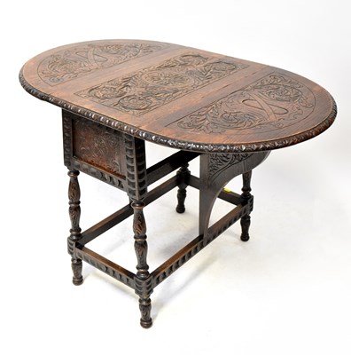 Lot 54 - A 20th century oak occasional table with...