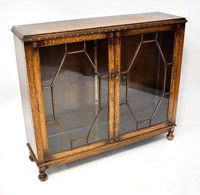 Lot 29 - An early 20th century oak display cabinet with...