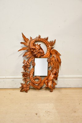 Lot 188 - An unusual Continental carved pine wall mirror...