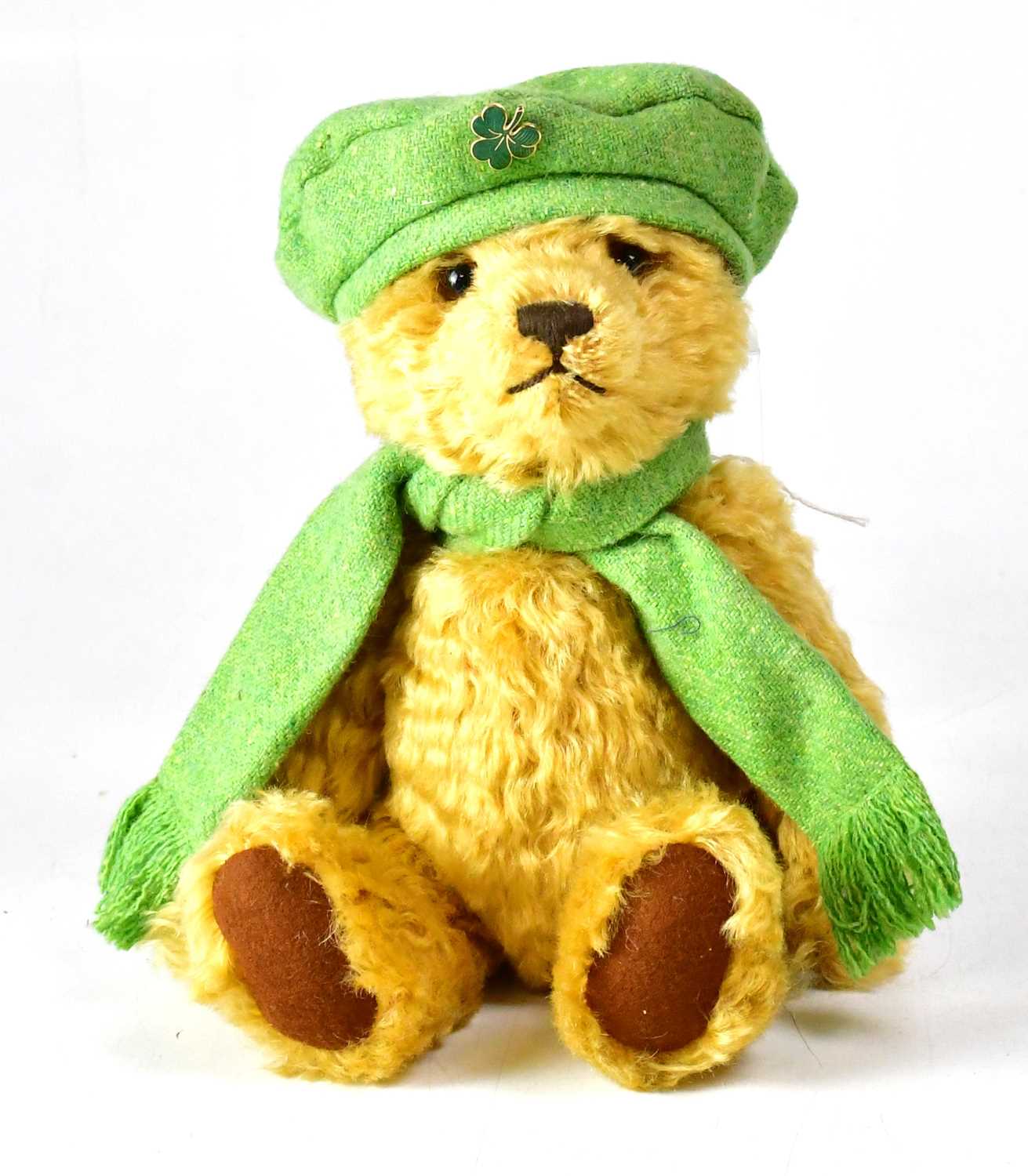 Lot 350 - STEIFF; a golden bear wearing green scarf and...