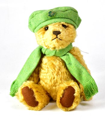 Lot 350 - STEIFF; a golden bear wearing green scarf and...