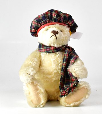 Lot 357 - STEIFF; a golden bear wearing tartan scarf and...