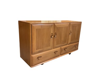 Lot 6 - ERCOL; a light elm sideboard, with pair of...