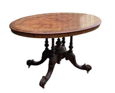 Lot 25 - A Victorian walnut oval loo table, on carved...