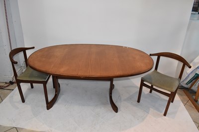 Lot 38 - A teak dining suite comprising extending table...