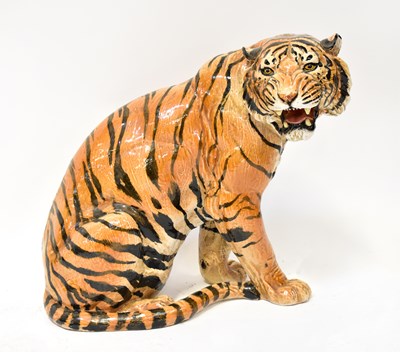 Lot 160 - A large ceramic figure of a seated tiger,...