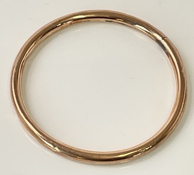 Lot 612 - A 9ct rose gold fixed hoop bangle, internal...