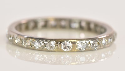 Lot 570 - A white metal diamond set full eternity ring,...