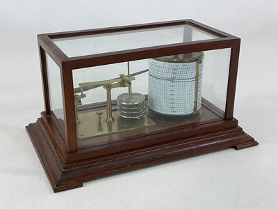 Lot 95 - An oak cased barograph raised on spreading...