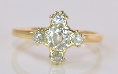 Lot 534 - A yellow metal diamond set cross ring, the...