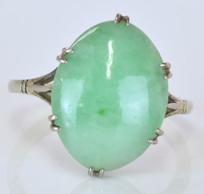 Lot 522 - An 18ct white gold and jade oval cabochon ring,...