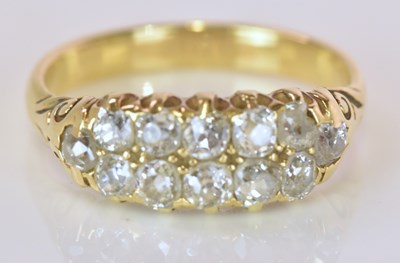 Lot 523 - A yellow metal twelve stone diamond ring...