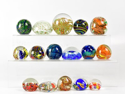 Lot 251 - A collection of glass paperweights to include...