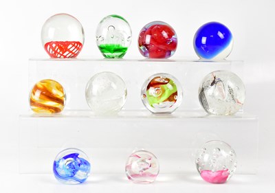 Lot 255 - A collection of glass paperweights to include...