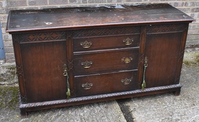 Lot 130 - An early 20th century oak sideboard with three...