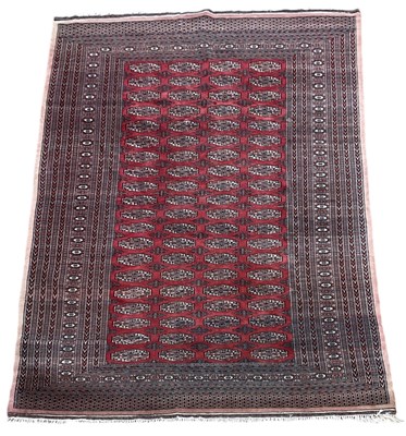 Lot 92 - A Persian red ground carpet with geometric...