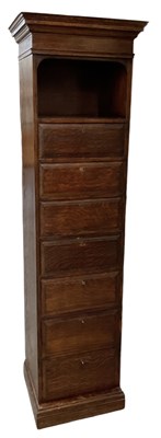 Lot 50 - A 1920s oak narrow chest of seven short...