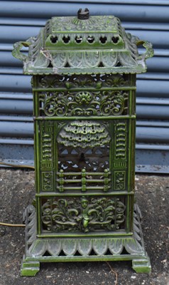 Lot 414 - A French green enamelled cast iron stove,...