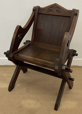 Lot 779 - An oak Glastonbury chair, with panel back and...