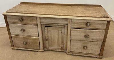 Lot 822 - A distressed pine seven drawer kitchen...