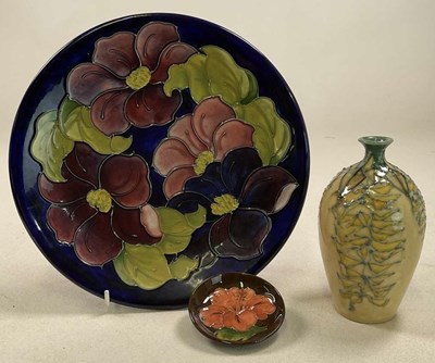 Lot 199 - MOORCROFT; a 'Clematis' pattern plate, signed...