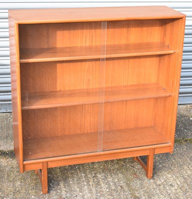 Lot 62 - A mid-century teak bookcase with pair of...