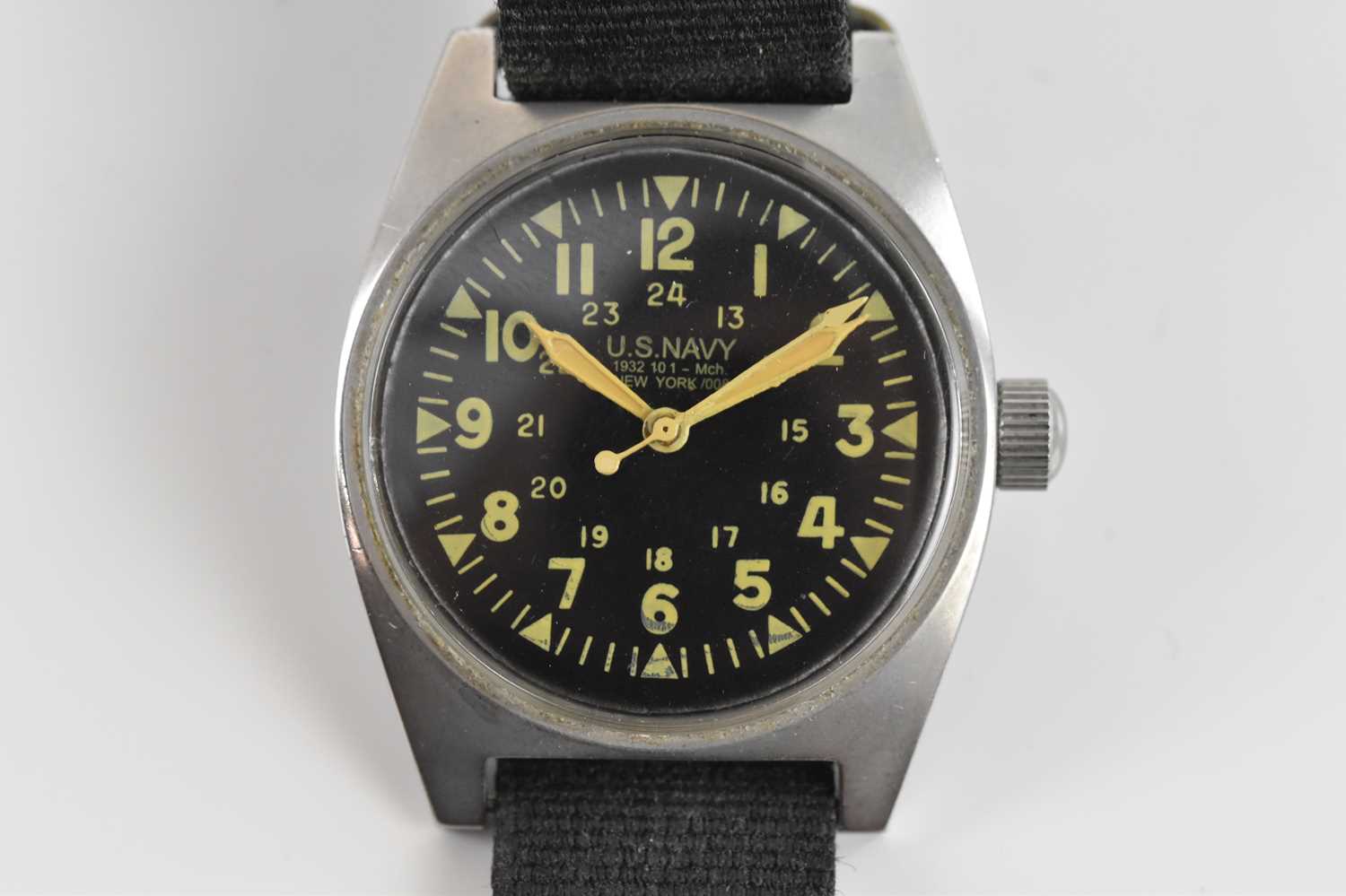 Lot 1879 - US NAVY; a manual wind wristwatch, the black...