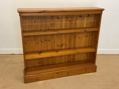 Lot 866 - A reproduction pine open bookcase with two...