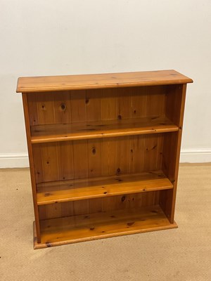 Lot 862 - A reproduction pine open bookcase with two...