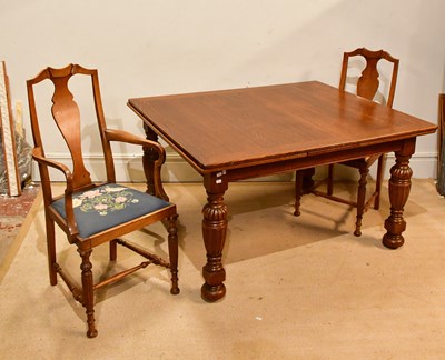 Lot 262 - An early 20th century draw-leaf dining table...