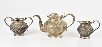 Lot 556 - An Indian white metal three piece tea service,...