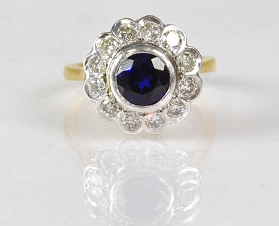 Lot 1062 - An 18ct yellow gold diamond and sapphire...