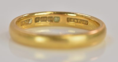 Lot 573 - A 22ct yellow gold wedding band, size M,...