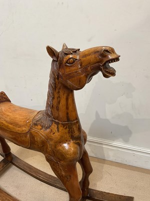 Lot 118 - A wooden rocking horse, with carved decoration,...