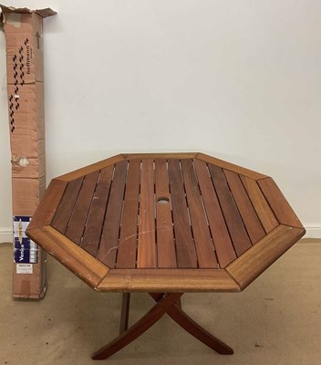 Lot 752 - A teak garden table, 74 x 122cm, and a parasol,...