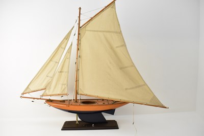 Lot 434 - A vintage pond yacht with three canvas sails,...