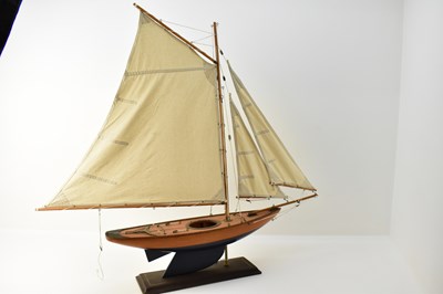 Lot 434 - A vintage pond yacht with three canvas sails,...
