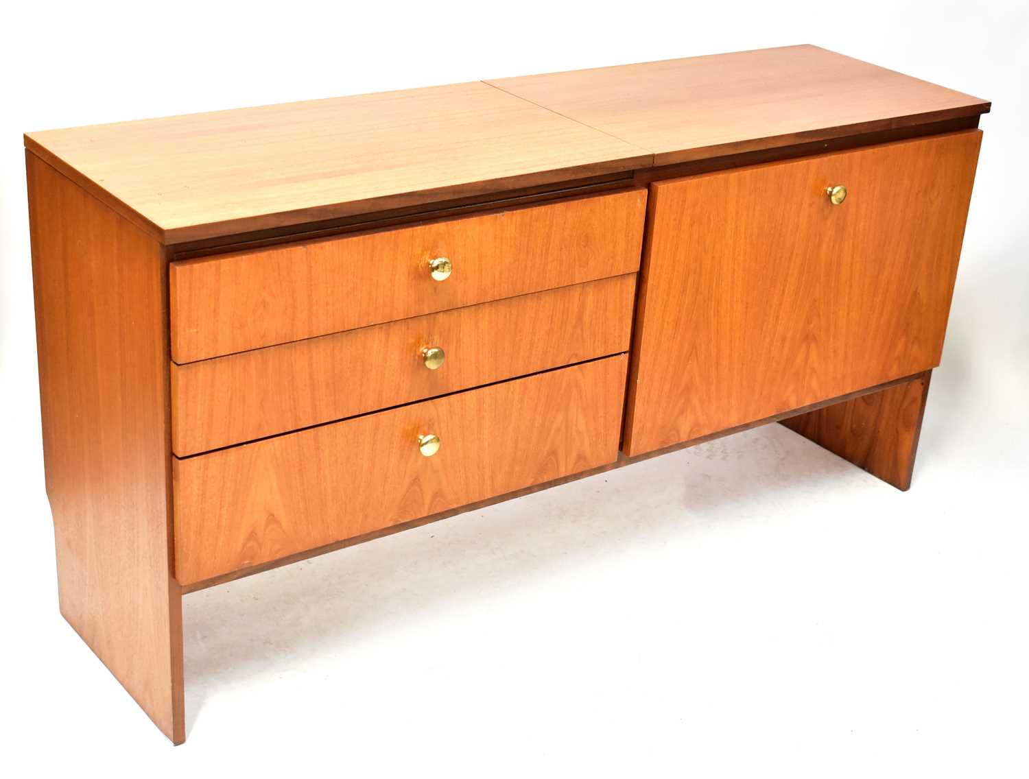 Lot 15 - MEREDEW; a teak sideboard, with three drawers...