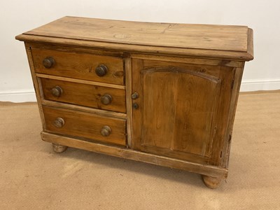 Lot 798 - A pine cupboard with three drawers and a...