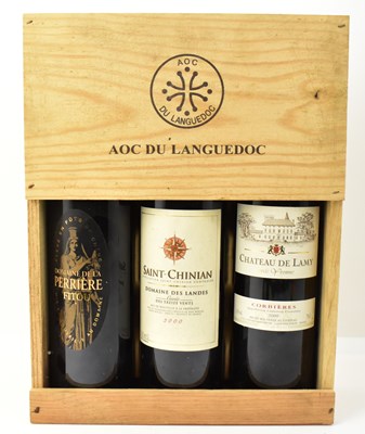 Lot 191 - A wooden case containing three wines...