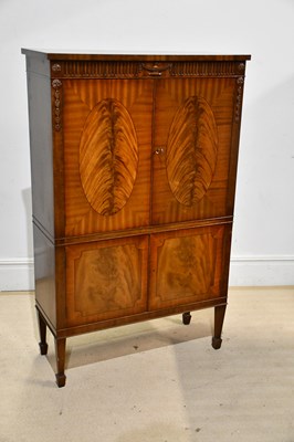 Lot 39 - A reproduction mahogany twin door cocktail...