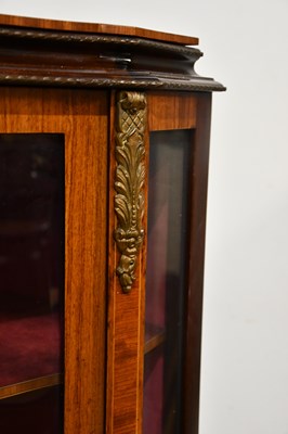 Lot 32 - A reproduction serpentine fronted vitrine with...