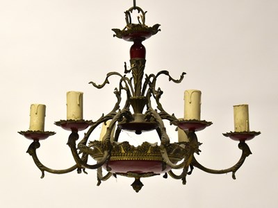 Lot 103 - An ornate brass and red painted electrolier...