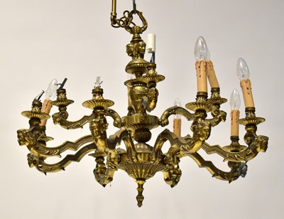 Lot 89 - An ornate gilt brass two-tier electrolier, the...