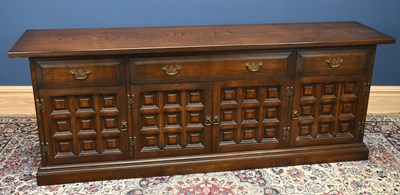 Lot 3035 - TOLEDO; a dark oak sideboard with three...