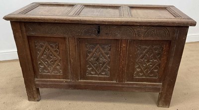 Lot 778 - A carved oak cased coffer with panelled top...