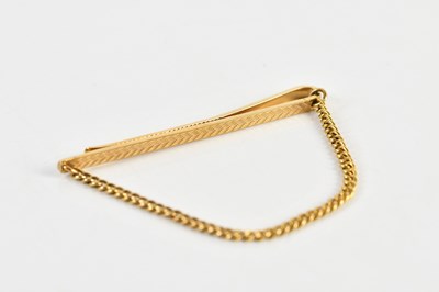 Lot 1250 - A 9ct yellow gold tie clip, with yellow metal...