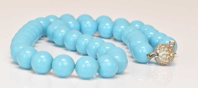 Lot 579 - A pale turquoise coloured bead necklace, with...