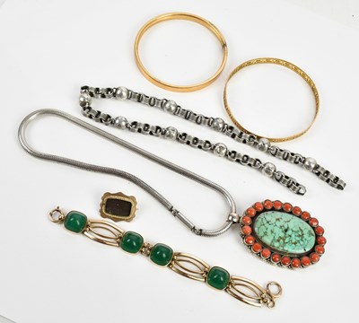 Lot 239 - A gold plated bracelet set with four green...