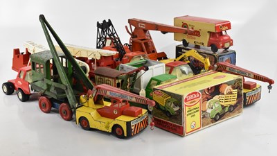 Lot 900 - A collection of tinplate toys including trucks...